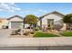 Single-story home with landscaped front yard, two-car garage, and attractive curb appeal at 27078 W Yukon Dr, Buckeye, AZ 85396