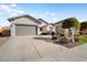 House exterior featuring a two-car garage and well-maintained landscaping at 27078 W Yukon Dr, Buckeye, AZ 85396