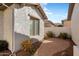 Brick-paved side patio with small landscaping at 27078 W Yukon Dr, Buckeye, AZ 85396