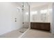 Modern bathroom showcasing a frameless glass shower and double sink vanity with gold fixtures at 1296 E Coconino Way, Gilbert, AZ 85298