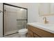 Bathroom featuring a walk-in shower with black trim and a stylish vanity with gold fixtures at 1296 E Coconino Way, Gilbert, AZ 85298