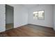 Bright bedroom featuring new hardwood floors and a large window at 1296 E Coconino Way, Gilbert, AZ 85298