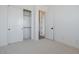 Bright bedroom featuring neutral carpeting and a closet with sliding doors at 1296 E Coconino Way, Gilbert, AZ 85298