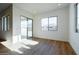 Bright living room with a sliding glass door, large windows, and neutral decor at 1296 E Coconino Way, Gilbert, AZ 85298