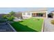 Spacious backyard with lush green lawn and a covered patio, ideal for relaxation at 17917 W Amberwood Dr, Goodyear, AZ 85338