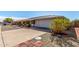 Front view of a ranch home with driveway and landscaping at 9409 W Glen Oaks N Cir, Sun City, AZ 85351