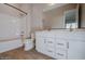 Bathroom featuring double sinks, white cabinets, and a shower-tub combo at 1284 E Coconino Way, Gilbert, AZ 85298