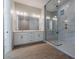 Bathroom showcasing dual vanity sinks, white cabinets, and glass-enclosed shower at 1284 E Coconino Way, Gilbert, AZ 85298