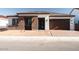 Charming single-story home featuring a brick facade, a two-car garage, and desert landscaping at 1284 E Coconino Way, Gilbert, AZ 85298