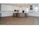 Spacious kitchen with white cabinets, a large island, stainless steel appliances, and wood-look tile flooring at 1284 E Coconino Way, Gilbert, AZ 85298