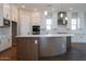 Kitchen island featuring a white countertop, wood-look base, and modern lighting fixtures at 1284 E Coconino Way, Gilbert, AZ 85298