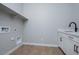 Laundry room with utility sink, white cabinetry, and washer/dryer hookups at 1284 E Coconino Way, Gilbert, AZ 85298