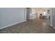 Open-concept living room leading to a kitchen with white cabinets and stainless steel appliances at 1284 E Coconino Way, Gilbert, AZ 85298