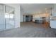 Open-concept living room with wood-look tile flooring, a kitchen island, and access to the backyard at 1284 E Coconino Way, Gilbert, AZ 85298
