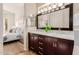 Bathroom featuring dual sinks, updated lighting, and a view into the bedroom at 3055 N Red Mtn # 77, Mesa, AZ 85207