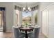 Cozy dining area features round table, seating for four, a chandelier, and a bay window at 3055 N Red Mtn # 77, Mesa, AZ 85207