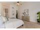 Wide angle view of the main bedroom with ensuite bath entrance, artwork and ceiling fan at 3055 N Red Mtn # 77, Mesa, AZ 85207