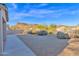 Backyard view showcasing gravel, desert plants, and a mountain backdrop at 4336 S Pony Rider Trl, Gold Canyon, AZ 85118