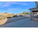 Backyard with gravel, desert plants, and a concrete patio at 4336 S Pony Rider Trl, Gold Canyon, AZ 85118