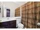 Clean bathroom with dark wood vanity, shower, and patterned curtain at 4336 S Pony Rider Trl, Gold Canyon, AZ 85118