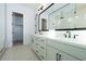 Bright bathroom featuring double sinks, modern fixtures, and a large mirror at 1300 E Penedes Dr, Gilbert, AZ 85298