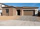 Charming single-story home with brick accents and a paved driveway leading to a two-car garage at 1300 E Penedes Dr, Gilbert, AZ 85298