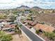 Neighborhood aerial view showing single Gathering homes with tile roofs, desert landscaping, and mountain views at 1017 E Grandview Rd, Phoenix, AZ 85022
