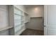 Spacious walk-in closet with shelving and clothing rods for organization at 11465 E Utah Ave, Mesa, AZ 85212