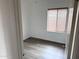 Bedroom with a window, neutral walls, and modern gray wood flooring at 11560 W Kinderman Dr, Avondale, AZ 85323