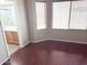 Bedroom with wood floors leads into the bathroom with a shower and a sink with wooden cabinetry at 11560 W Kinderman Dr, Avondale, AZ 85323