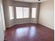 Bright bedroom featuring wood floors and lots of natural light from the many windows at 11560 W Kinderman Dr, Avondale, AZ 85323
