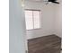 Bright bedroom featuring neutral walls, a window, ceiling fan, and modern gray flooring at 11560 W Kinderman Dr, Avondale, AZ 85323