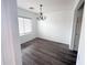 Bright dining room featuring neutral walls, a chandelier, and modern gray flooring at 11560 W Kinderman Dr, Avondale, AZ 85323