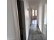 Hallway featuring neutral walls, an open concept, and modern gray flooring at 11560 W Kinderman Dr, Avondale, AZ 85323