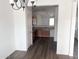Open kitchen with wood cabinets, stainless appliances, and modern gray wood flooring at 11560 W Kinderman Dr, Avondale, AZ 85323