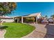 Lush backyard featuring a patio, green lawn, and mature trees at 22364 N 67Th Dr, Glendale, AZ 85310