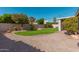 A spacious, landscaped backyard with green grass and brick patio at 22364 N 67Th Dr, Glendale, AZ 85310