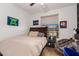 Comfortable bedroom featuring a wooden bed frame, beige linen, and bright natural light at 22364 N 67Th Dr, Glendale, AZ 85310