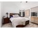 Comfortable primary bedroom with a large window, wood floors, and tasteful decor at 22364 N 67Th Dr, Glendale, AZ 85310