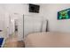 Well-lit bedroom featuring closet doors and a gaming-themed decor at 22364 N 67Th Dr, Glendale, AZ 85310