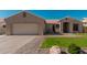 Charming single-story home featuring a well-manicured lawn and tile roof at 22364 N 67Th Dr, Glendale, AZ 85310