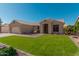 Charming single-story home featuring a well-manicured lawn and tile roof at 22364 N 67Th Dr, Glendale, AZ 85310