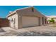 Side view of the home showing a long driveway and garage at 22364 N 67Th Dr, Glendale, AZ 85310