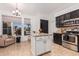 Modern kitchen with black cabinets, stainless steel appliances, and a central island at 22364 N 67Th Dr, Glendale, AZ 85310