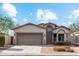 Charming single-story home with desert landscaping, a two-car garage, and neutral colors under a beautiful, partly cloudy sky at 6658 E San Cristobal Way, Gold Canyon, AZ 85118