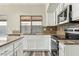 Updated kitchen with granite countertops, stainless steel appliances and white cabinetry adding to the modern aesthetic of the space at 6658 E San Cristobal Way, Gold Canyon, AZ 85118