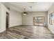 Open living area featuring modern gray vinyl flooring, neutral walls, ceiling fan and sliding glass doors to backyard at 6658 E San Cristobal Way, Gold Canyon, AZ 85118