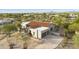 Aerial view of desert home with two-car garage, lush landscaping, and a tile roof at 7928 E Parkview Ln, Scottsdale, AZ 85255