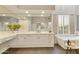 Bright bathroom showcasing a large mirror, a soaking tub and a vanity with white cabinetry at 7928 E Parkview Ln, Scottsdale, AZ 85255