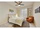 Bedroom with a ceiling fan, neutral decor, and natural light from a window with plantation shutters at 7928 E Parkview Ln, Scottsdale, AZ 85255